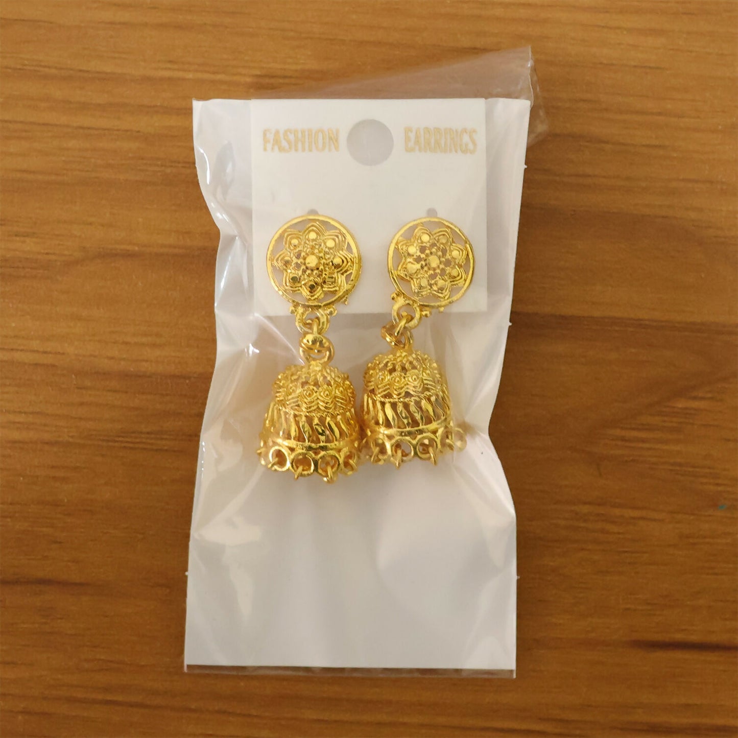 Gold plated floral jhumka earrings styled with ethnic wear