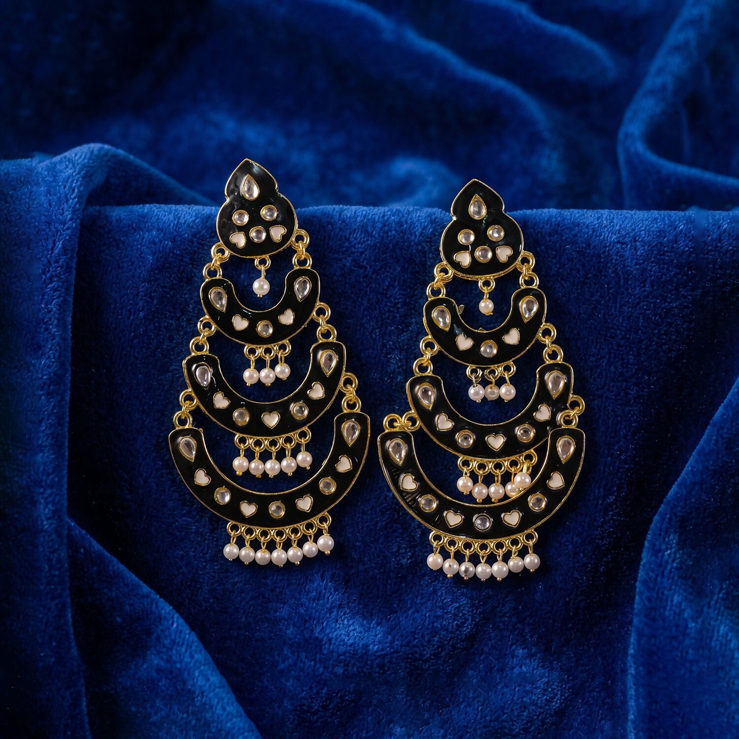 Black chandbali earrings displayed on a neutral background