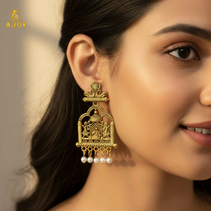 Close-up of intricate bridal doli design on gold-tone temple earrings