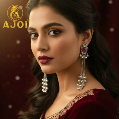 Closeup of Kashmiri ruby chain drop earrings with elegant silver-tone finish