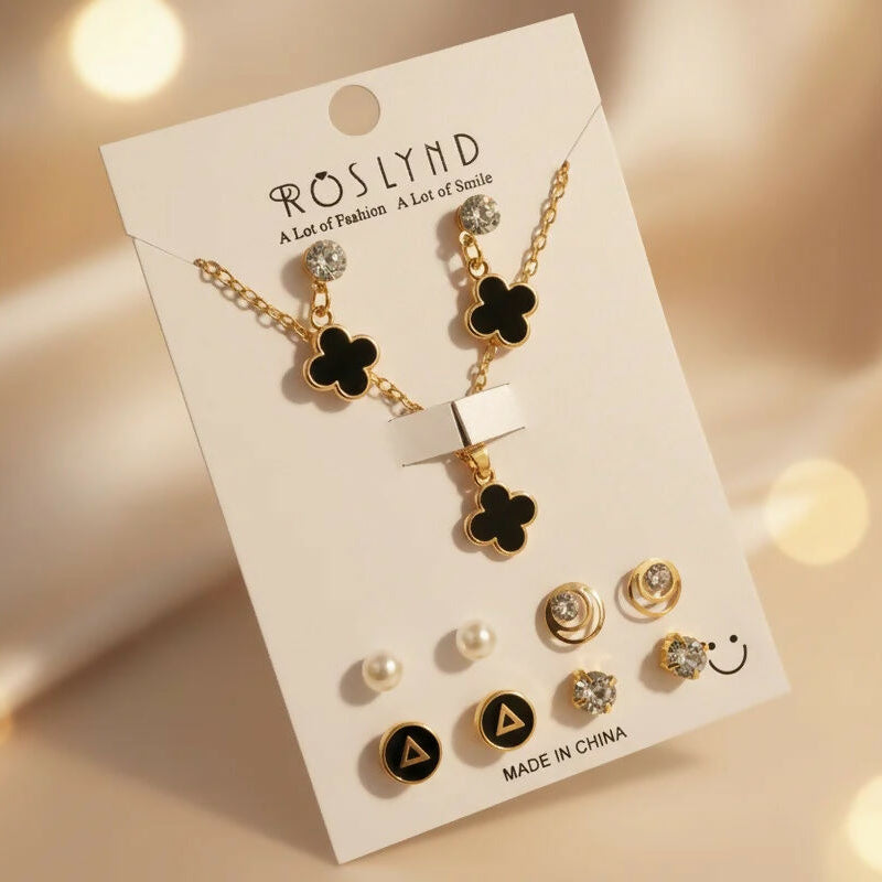 Women wearing gold plated black clover pendant necklace and stud earrings