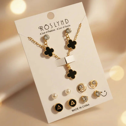 Women wearing gold plated black clover pendant necklace and stud earrings