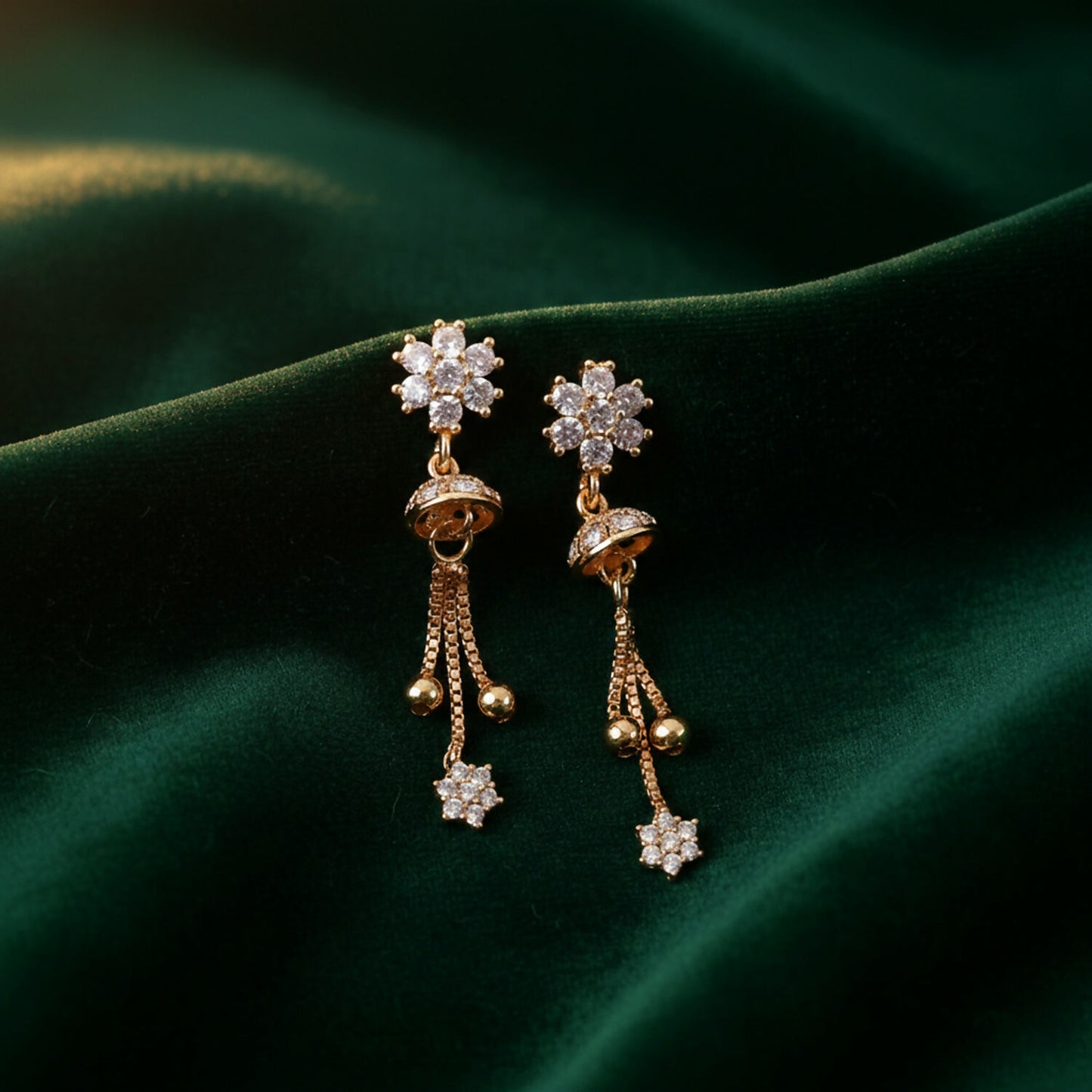 Pair of lightweight floral crystal drop earrings with sparkling studs and gold chain tassels