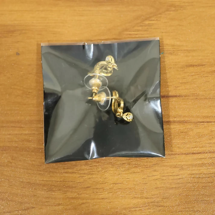 Classic Gold Tone Designer Leaf Earrings With Ruby Accent And Graceful Hanging Drop