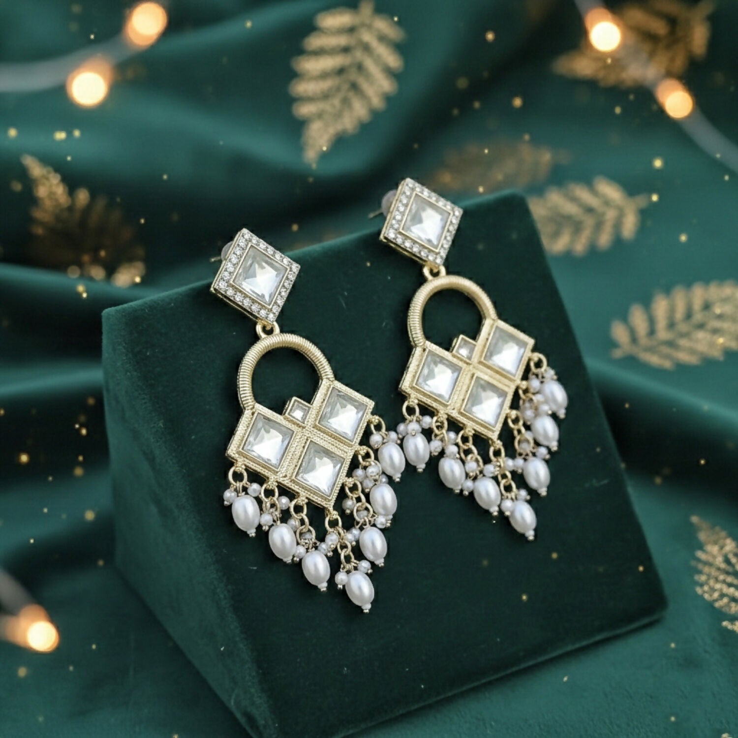Gold-toned Kundan chandelier earrings with dangling teardrop white pearls