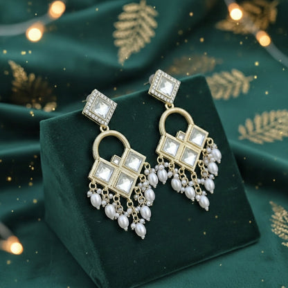 Gold-toned Kundan chandelier earrings with dangling teardrop white pearls