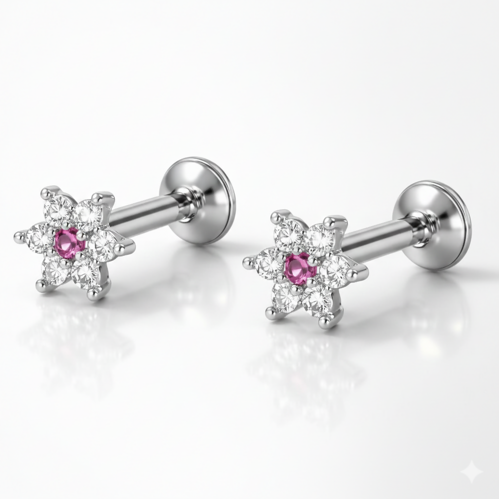 Front view of silver-plated stud earrings featuring vibrant ruby stones in floral design