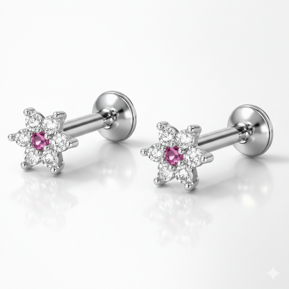 Front view of silver-plated stud earrings featuring vibrant ruby stones in floral design