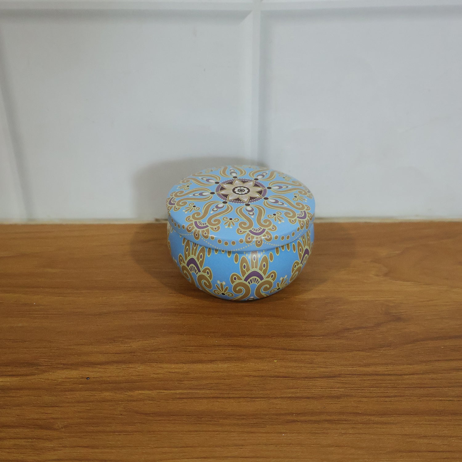 Mandala printed metal candle tin in home décor setting