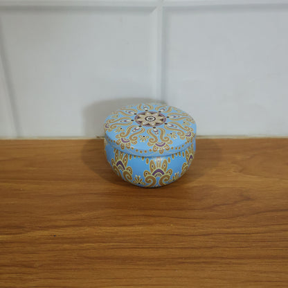 Mandala printed metal candle tin in home décor setting