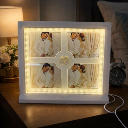 Close-up of LED illuminated white photo frame collage with four pictures