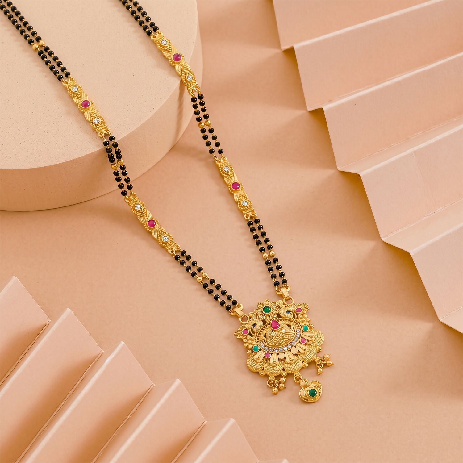 Side view of the floral lotus pendant showcasing pink enamel petals and intricate design