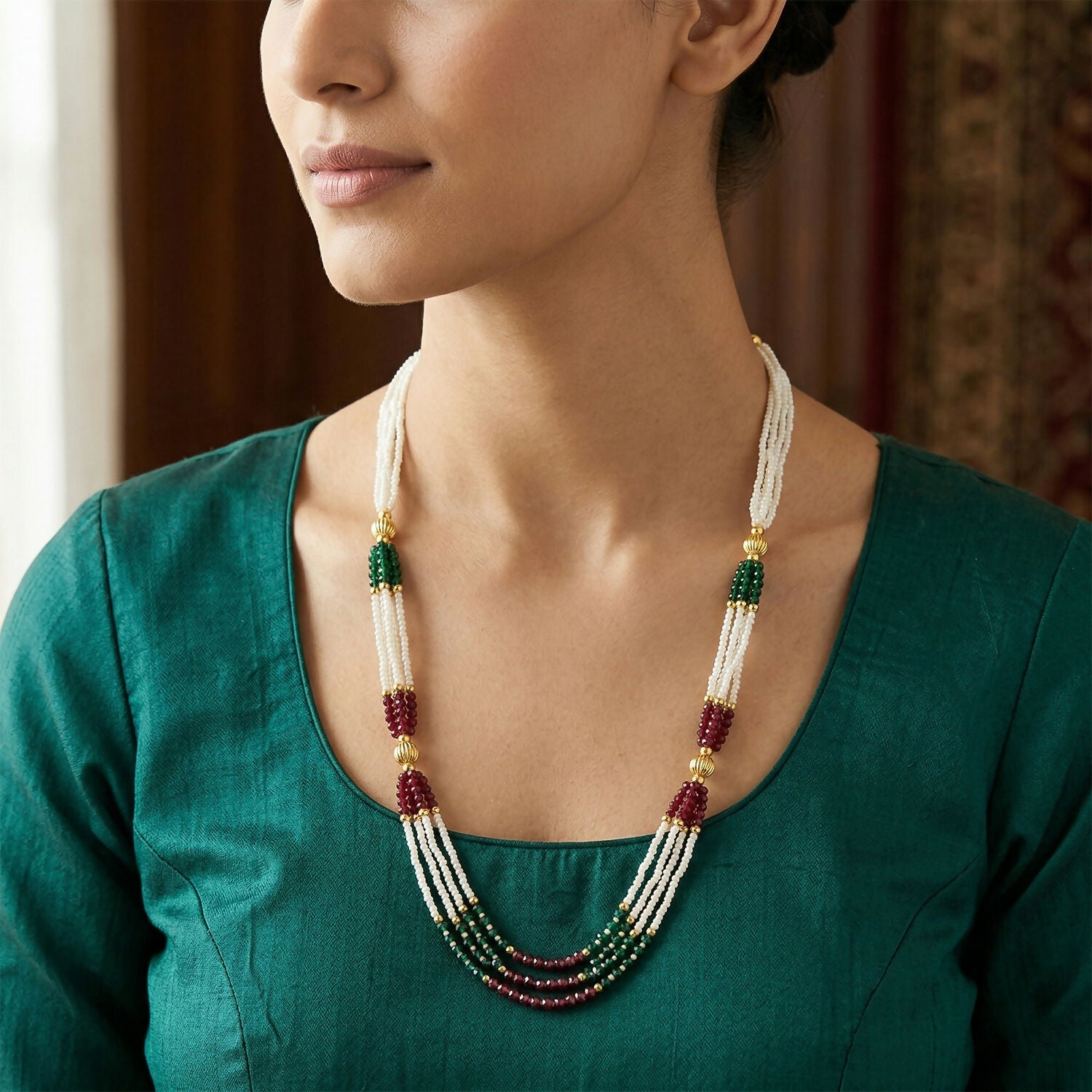 Close-up of white pearls and colorful bead accents on mala necklace