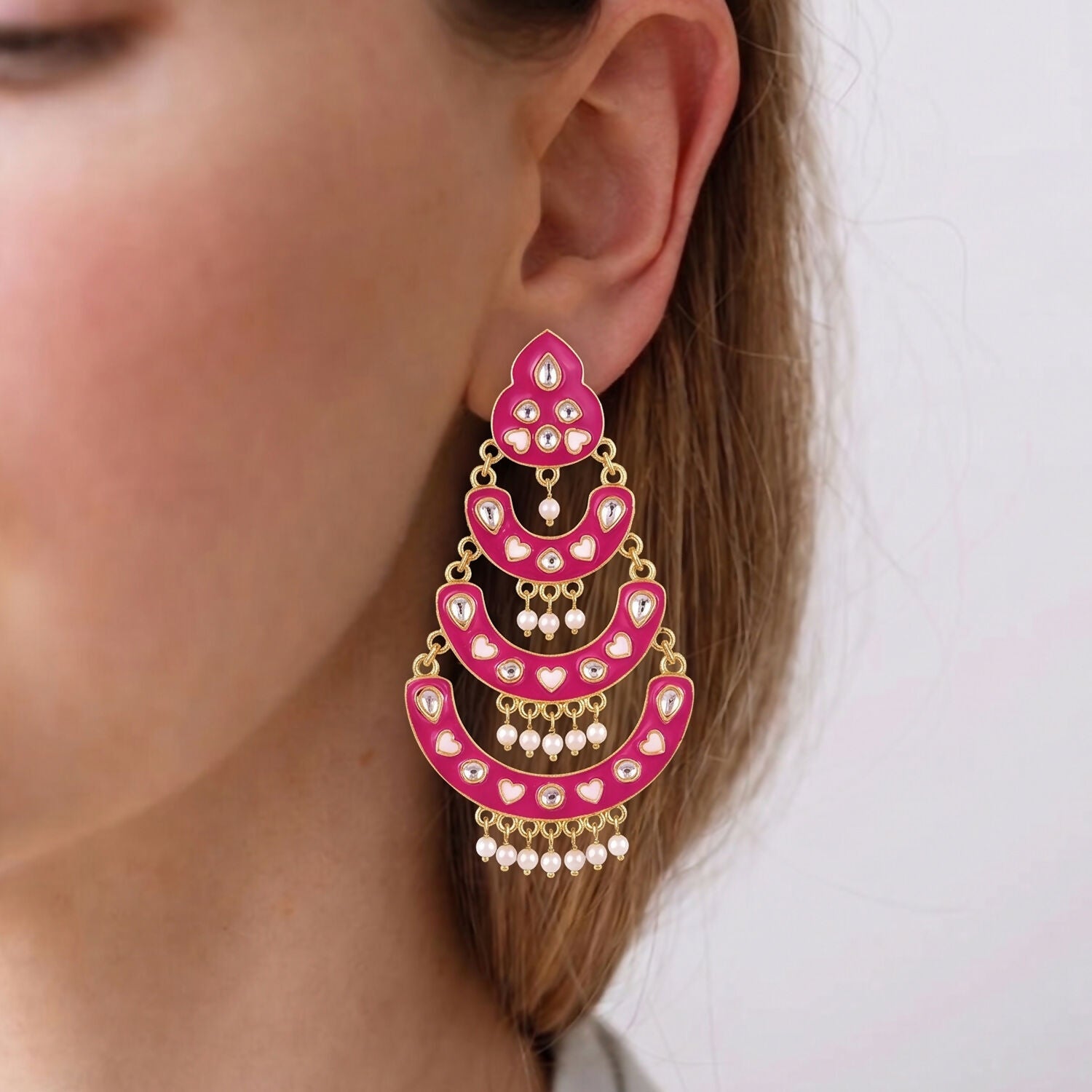 Pearl drops hanging from layered chandbali earrings