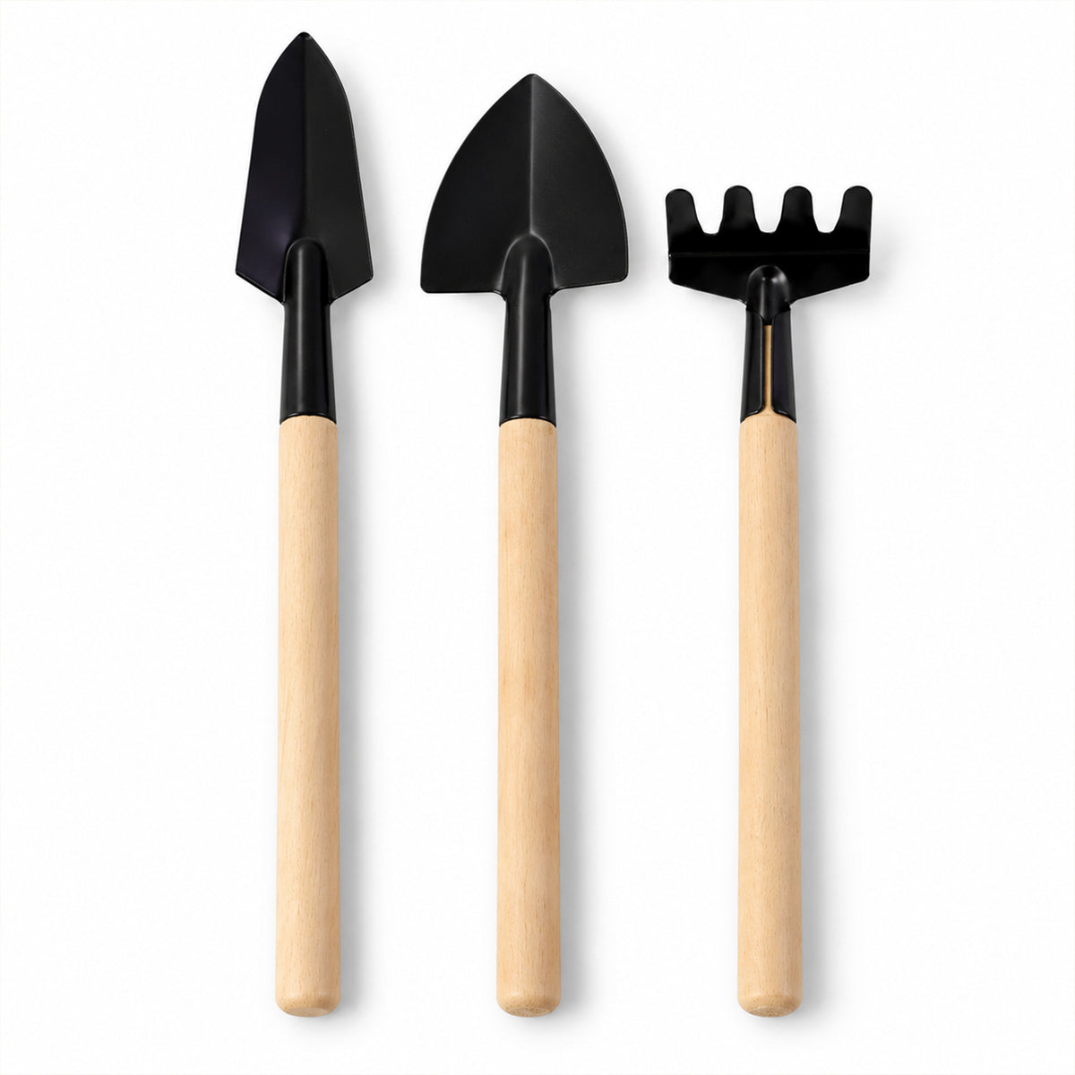 Three small gardening tools, including two trowels and a rake, stand upright on a plain white background.