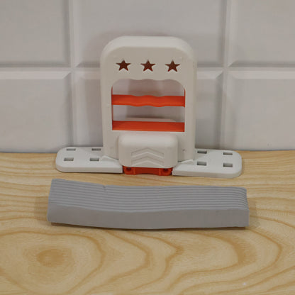 The white and orange mini mop is disassembled on a light wooden surface, with the gray sponge separate.