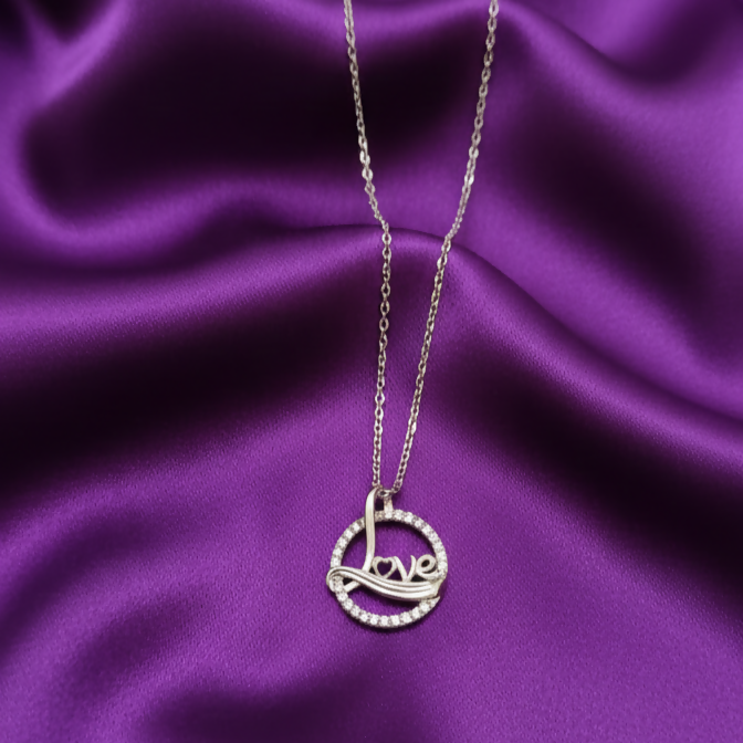 Love script silver pendant necklace with circular design and sparkling crystal accents