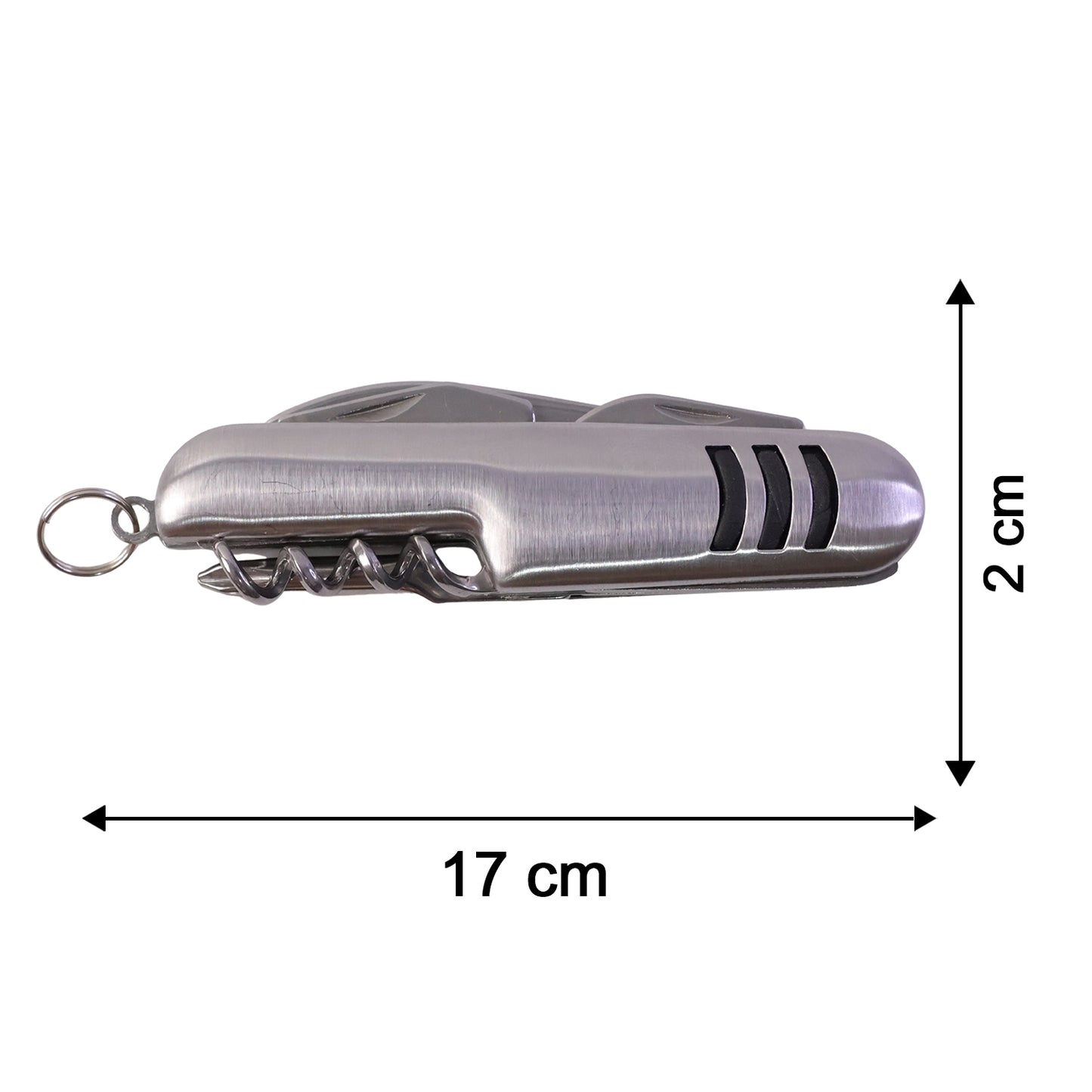A hand uses the silver multi-tool's saw blade to cut a small branch from a tree.