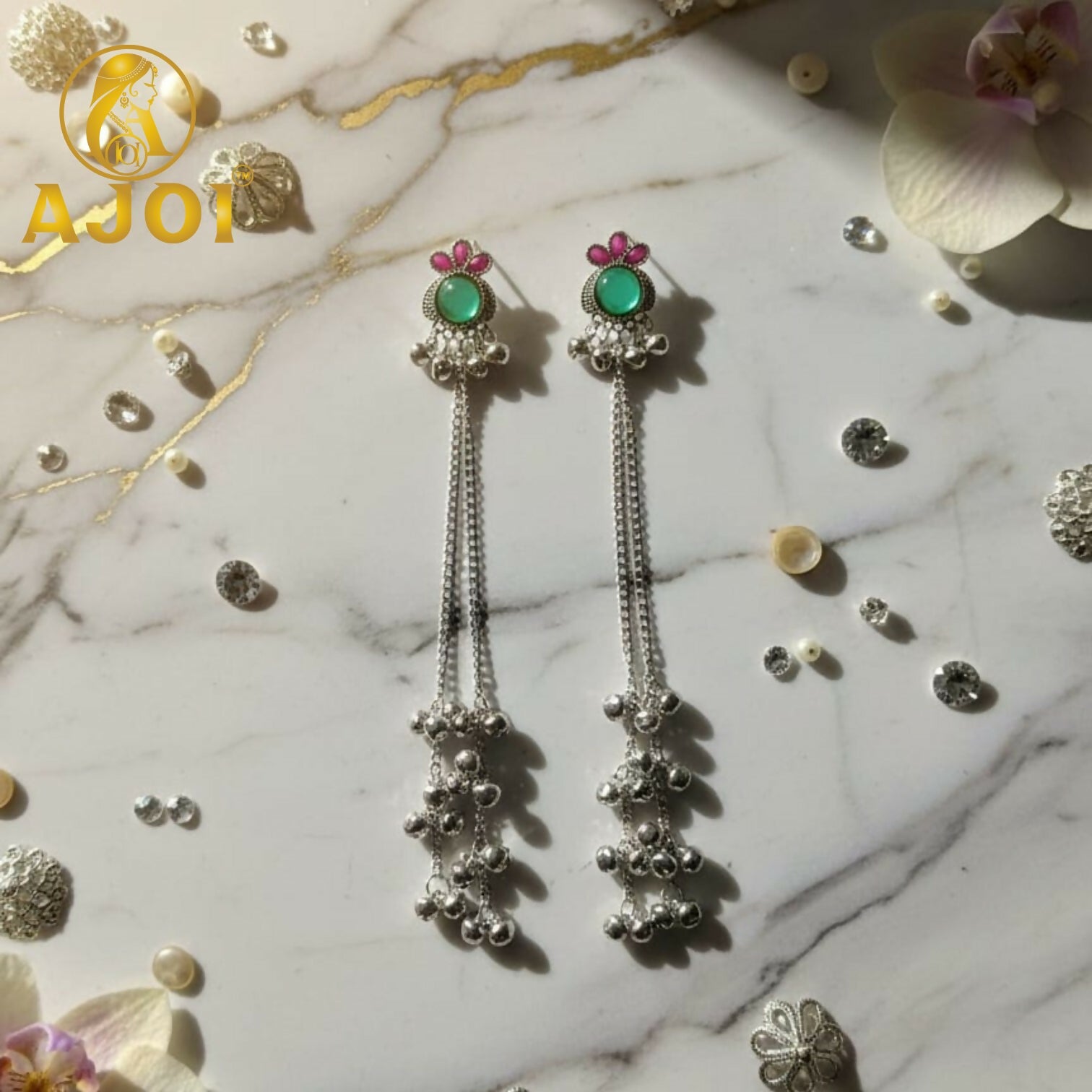 Twin silver chains adorned with tiny ghungroo bells on earrings