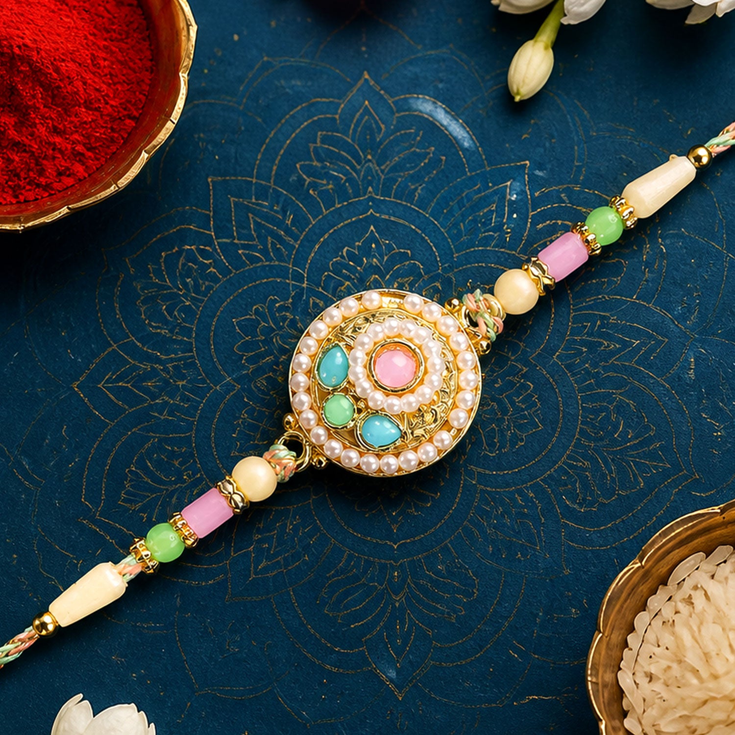 Pearl Bordered Round Pendant Rakhi with Turquoise and Pink Center