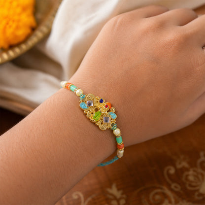 Oxidized Kundan Cluster Pendant Rakhi with Teal and Coral Beads