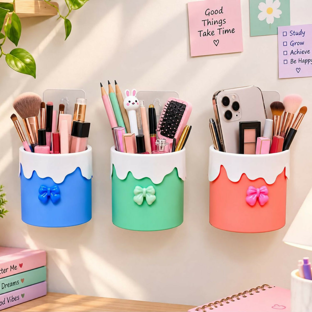 Three colorful organizers mounted on a wall, holding makeup brushes, cosmetics, and a smartphone.