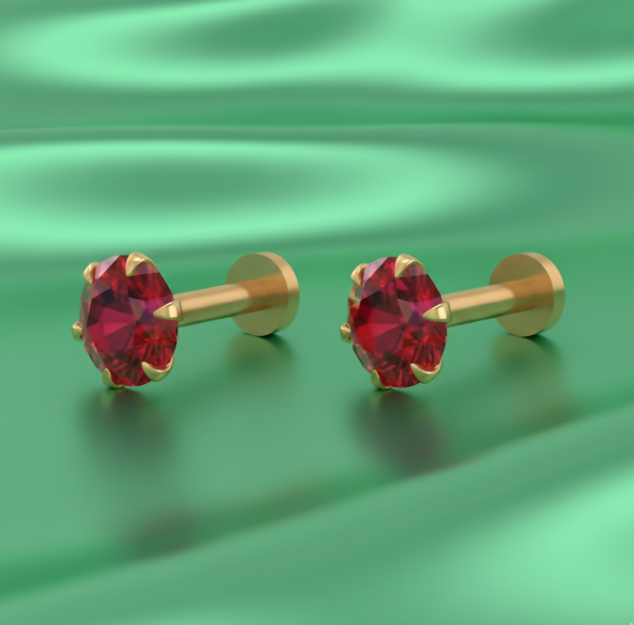 Close-up view of red gemstone set in gold plated nosepin stud