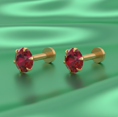 Close-up view of red gemstone set in gold plated nosepin stud