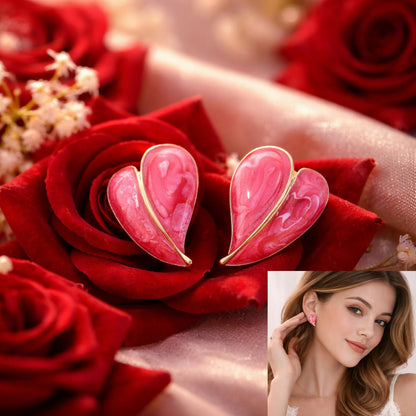 Red leaf stud earrings displayed on a light surface