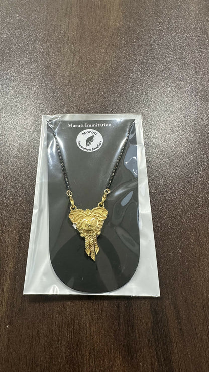 CZ-studded heart with a couple silhouette, this pendant is cast in gold-toned imitation metal to celebrate the sacred bond of marriage.