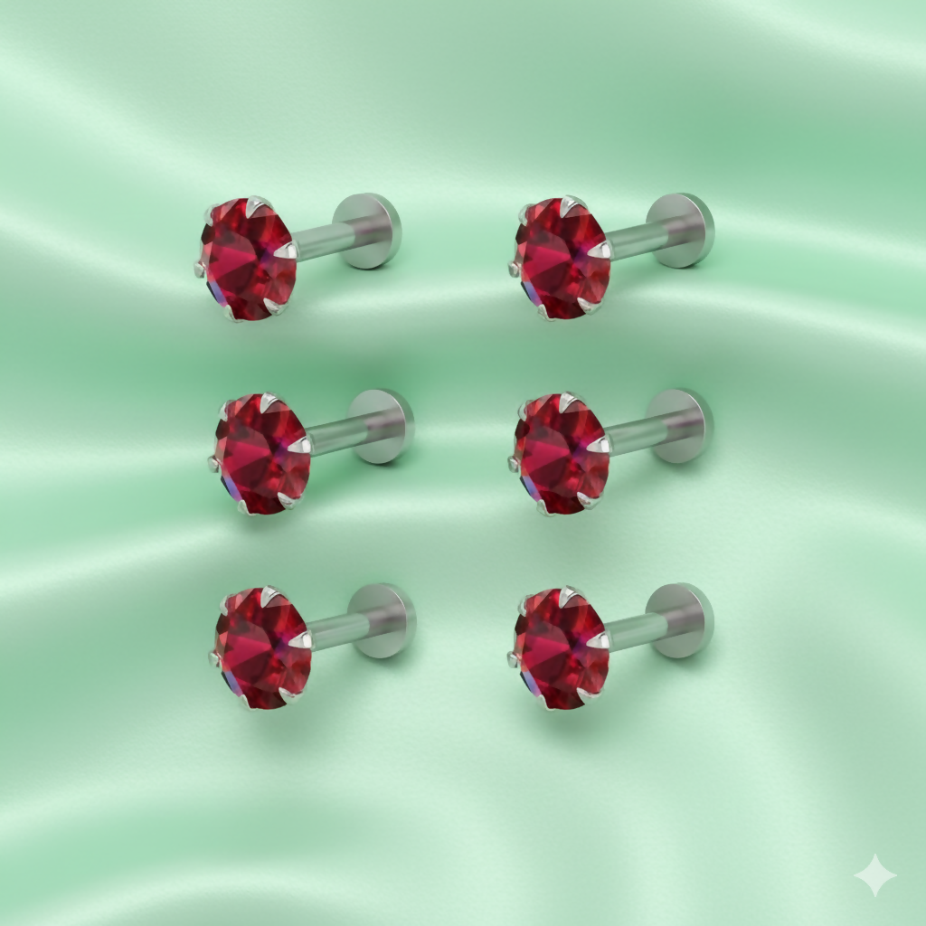 Close-up view of a red crystal labret nosepin stud highlighting the crystal sparkle