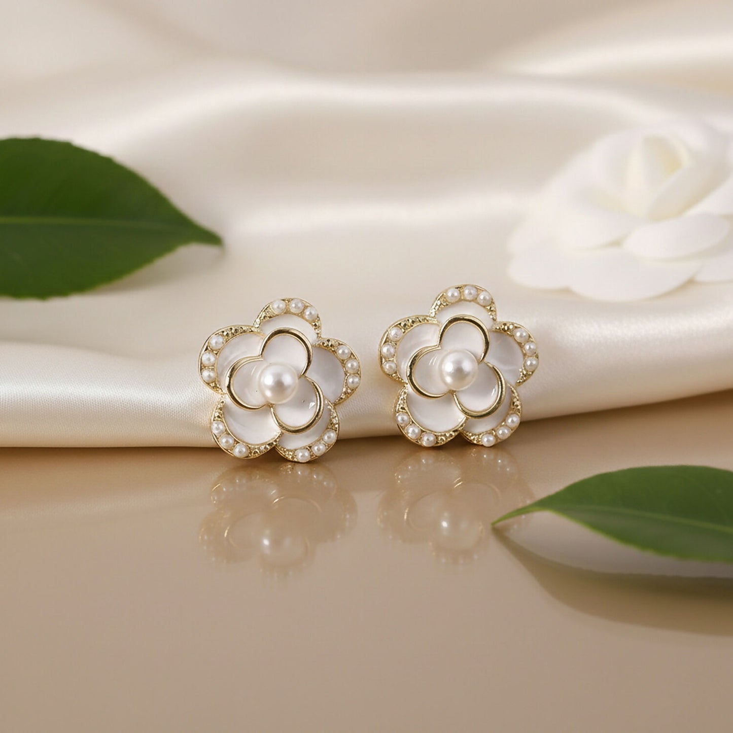 Gold-tone pearl heart drop earrings worn on ear