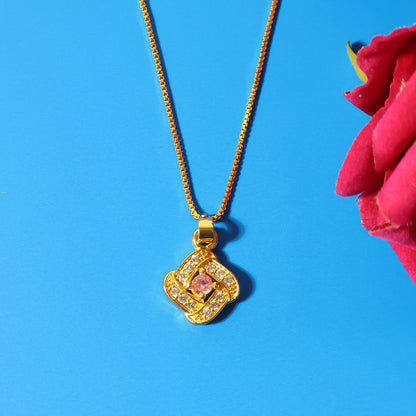 Refined pendant necklace showcasing radiant pink stone at its center and golden finish