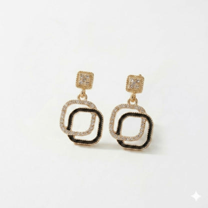 Close-up of elegant geometric earrings with black stone and rhinestones