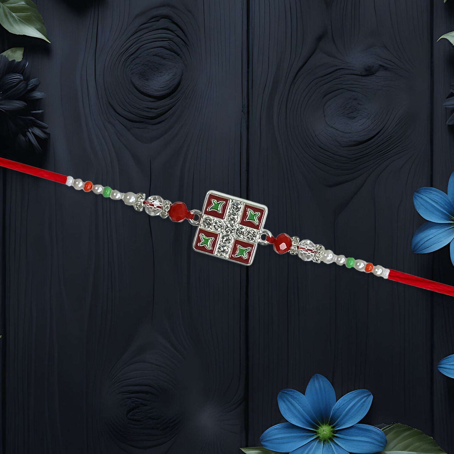 Close-up view of Meenakari Rakhi showing red and green enamel accents