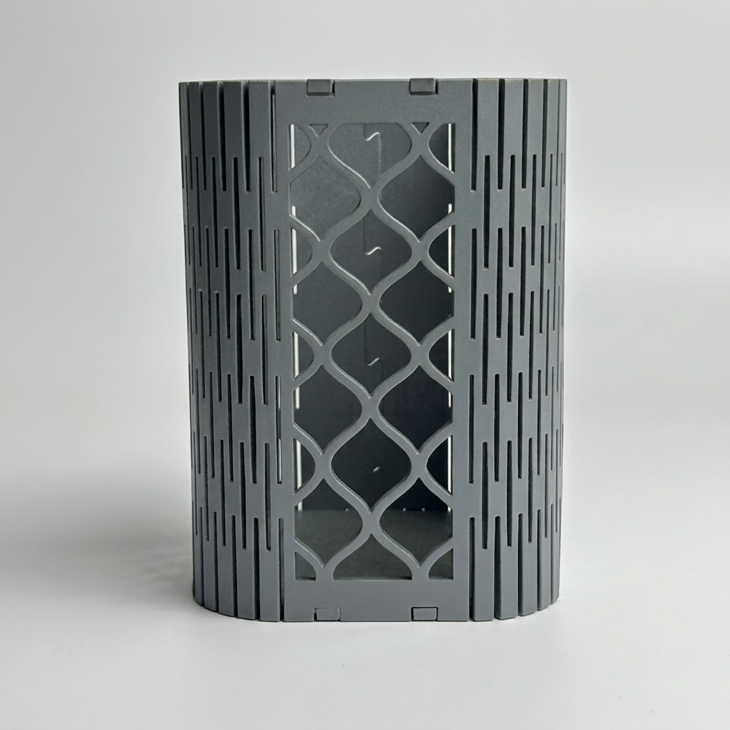Side profile of the geometric mesh pen holder, highlighting its MDF construction.