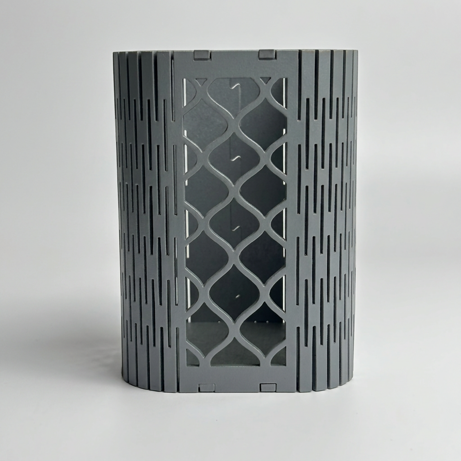 Side profile of the geometric mesh pen holder, highlighting its MDF construction.
