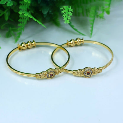 Side view of floral design bangle with sparkling stone