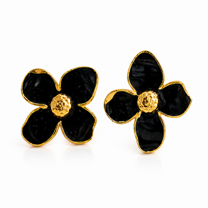 Close-up of black floral enamel design on earrings