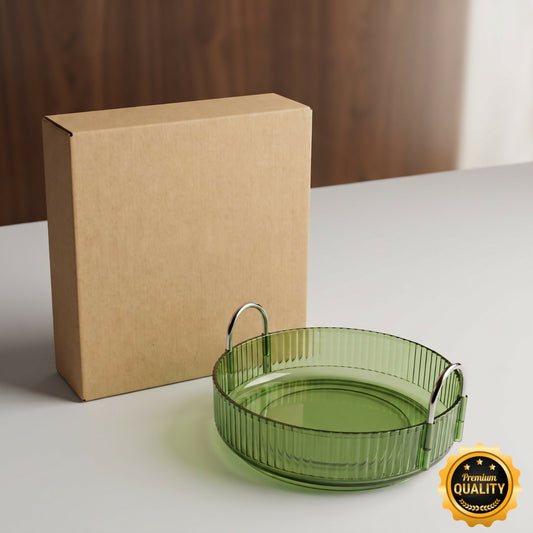 A green ribbed rotating tray with silver handles sits next to a brown cardboard box on a white surface.