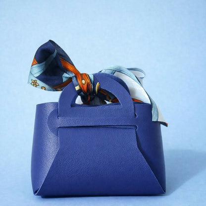 Mini handbag organizer with bow placed on a dressing table