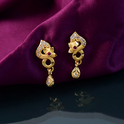 Side view of gold plated ruby and crystal drop earrings