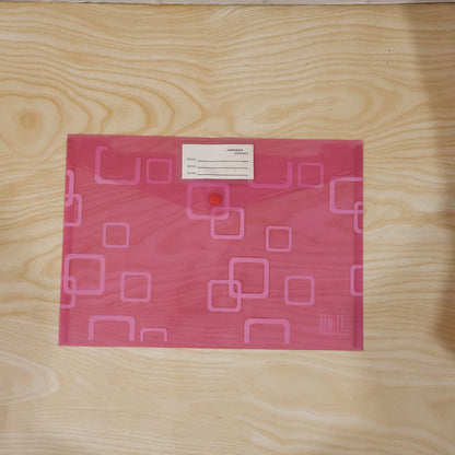A pink plastic document folder with a button closure and a white label, centered on a light wooden surface.