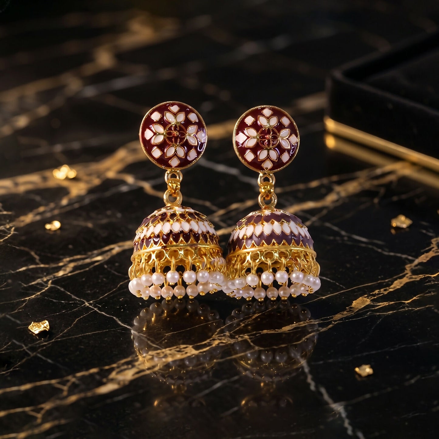 Pair of maroon stud jhumka earrings with pearl beads display