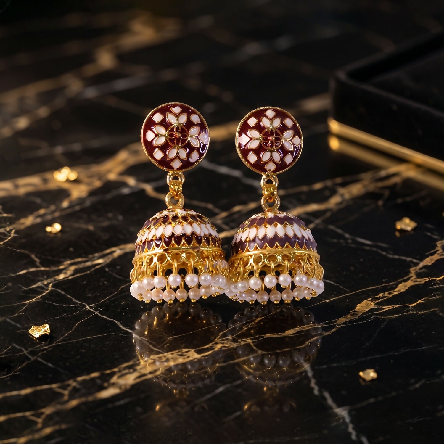 Pair of maroon stud jhumka earrings with pearl beads display