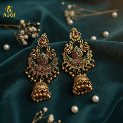 Gold plated peacock jhumka earrings with green and pink stones front view