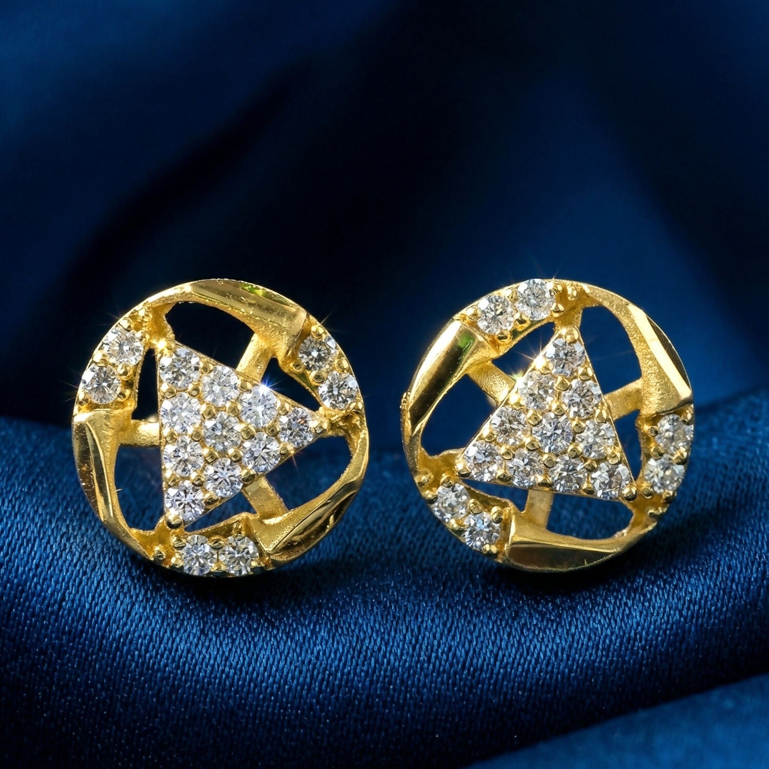 Close-up of gold stud earrings with intricate bell shape and sparkling stones