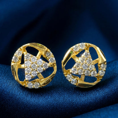 Close-up of gold stud earrings with intricate bell shape and sparkling stones
