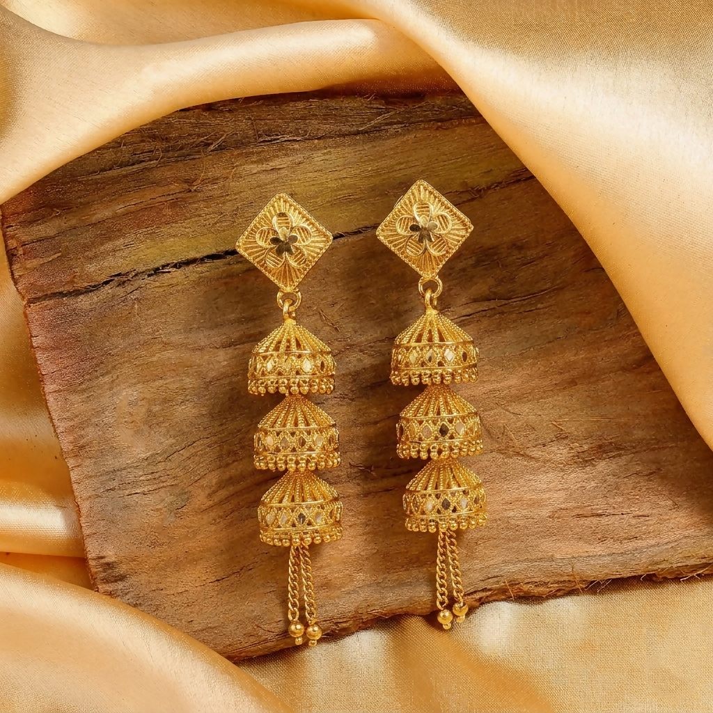 Close-up of traditional gold plated jhumka earrings
