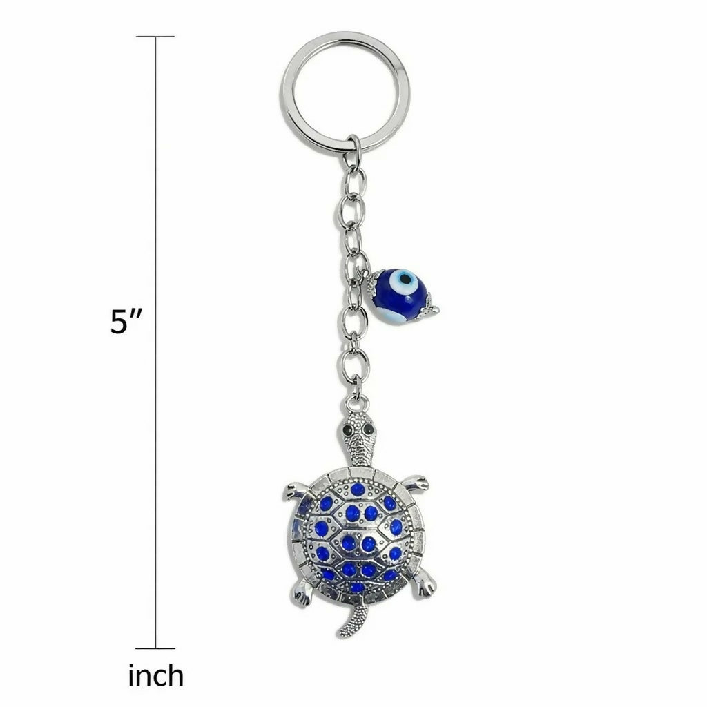 Detail of metal turtle keychain and evil eye key ring